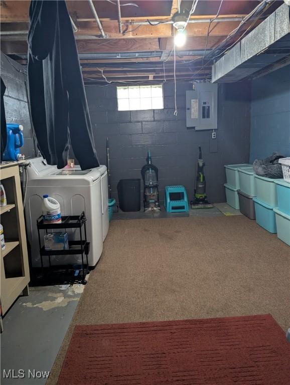 basement with washer and clothes dryer and electric panel