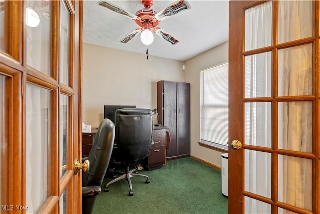 home office featuring ceiling fan, baseboards, dark colored carpet, and french doors