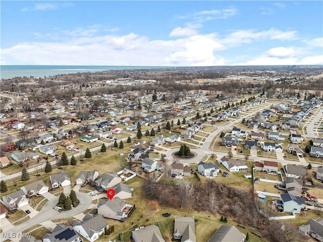 bird's eye view featuring a residential view and a water view