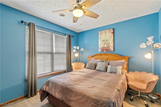 bedroom featuring carpet flooring, ceiling fan, a textured ceiling, and baseboards