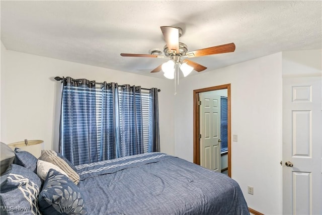 bedroom featuring a textured ceiling and a ceiling fan