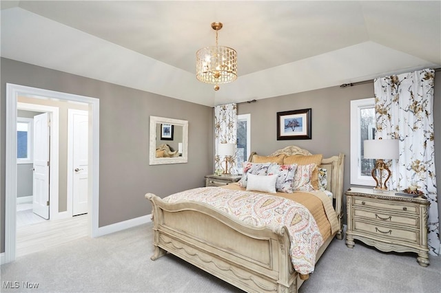 bedroom featuring baseboards, light colored carpet, a tray ceiling, vaulted ceiling, and a notable chandelier