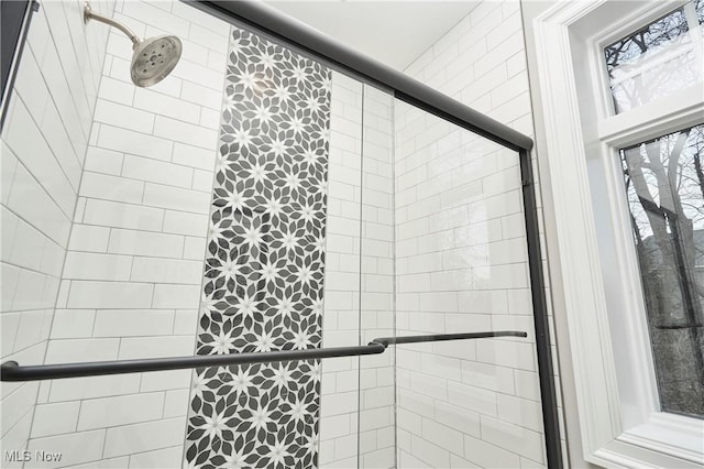 bathroom with tiled shower