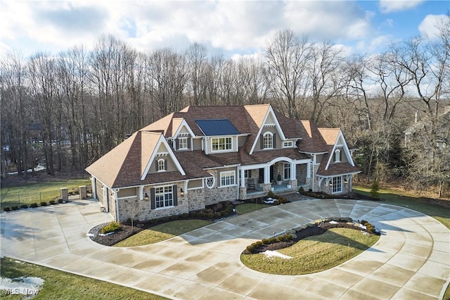 view of front of property featuring a front yard, concrete driveway, fence, and a chimney