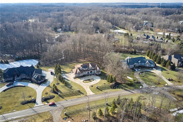 drone / aerial view featuring a forest view