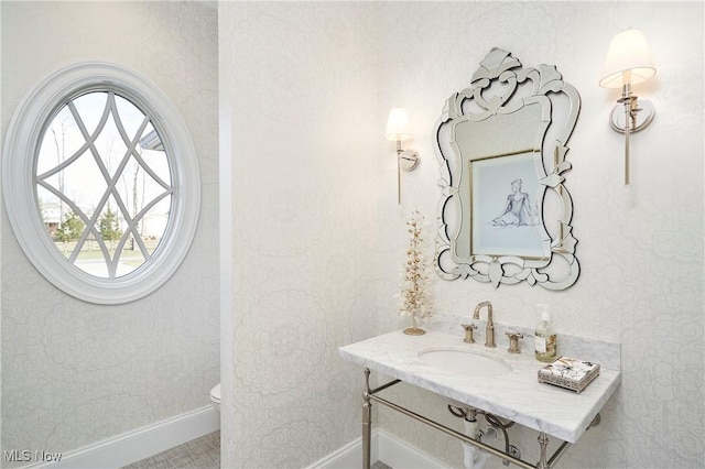 bathroom featuring wallpapered walls, vanity, toilet, and baseboards