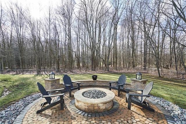 view of patio featuring fence and a fire pit