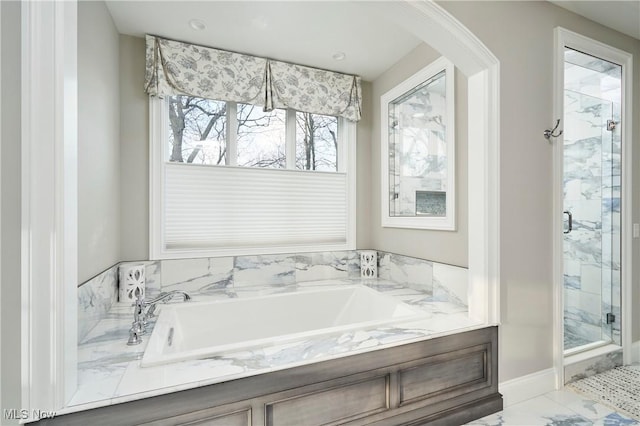 full bath with marble finish floor, a marble finish shower, and a bath