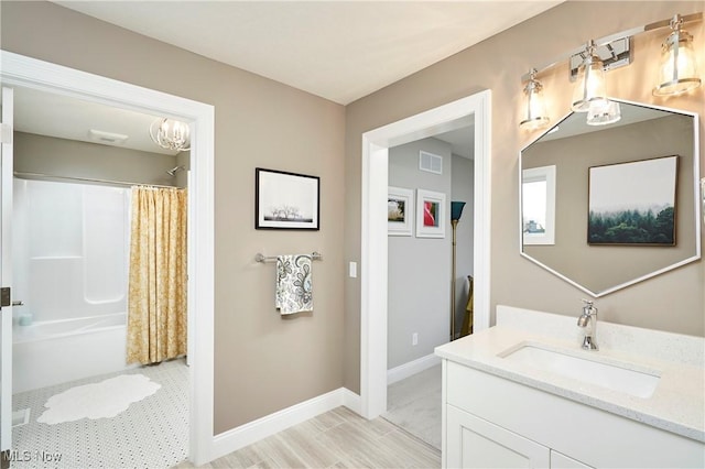 full bath with shower / bathtub combination with curtain, visible vents, vanity, and baseboards