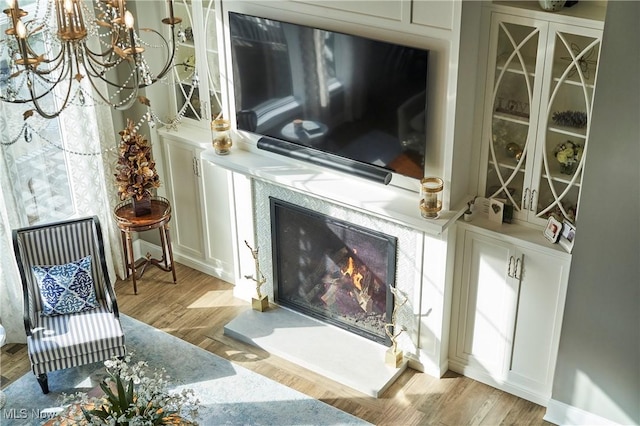 sitting room with a premium fireplace and wood finished floors