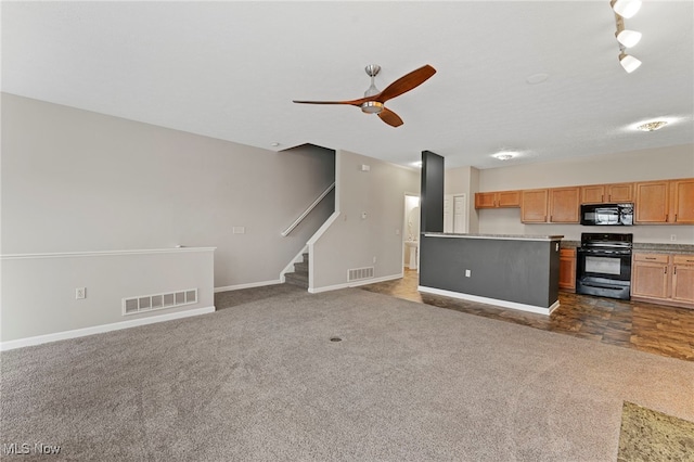 kitchen featuring black appliances, dark colored carpet, and visible vents