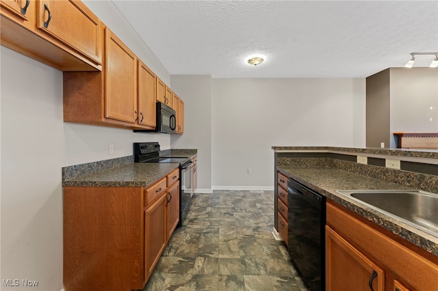 kitchen with baseboards, dark countertops, brown cabinets, a textured ceiling, and black appliances