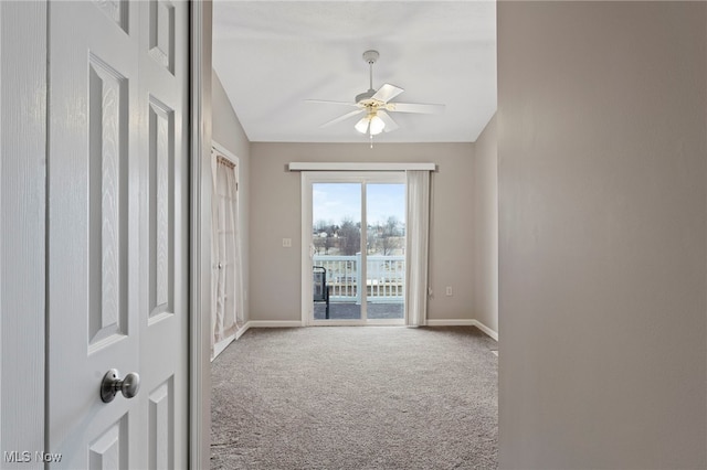 unfurnished room featuring lofted ceiling, a ceiling fan, baseboards, and carpet flooring