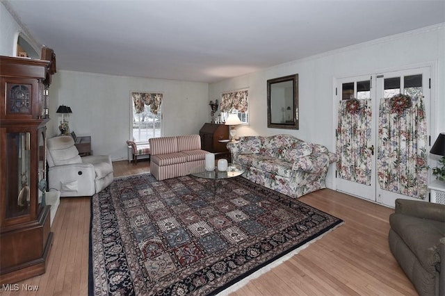 living area with wood finished floors and crown molding