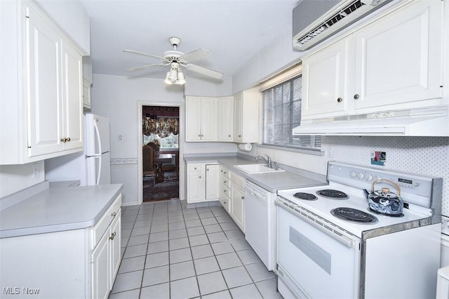 kitchen with light countertops, white cabinetry, a sink, white appliances, and under cabinet range hood