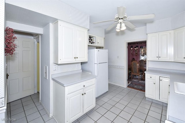 kitchen featuring white cabinets, ceiling fan, light countertops, and freestanding refrigerator