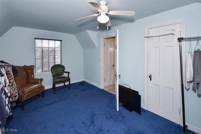 sitting room featuring carpet flooring, vaulted ceiling, baseboards, and ceiling fan