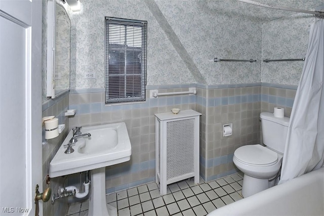 full bathroom with wallpapered walls, radiator, toilet, a wainscoted wall, and tile patterned floors