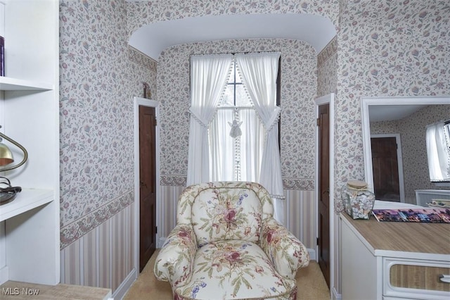 sitting room with wallpapered walls