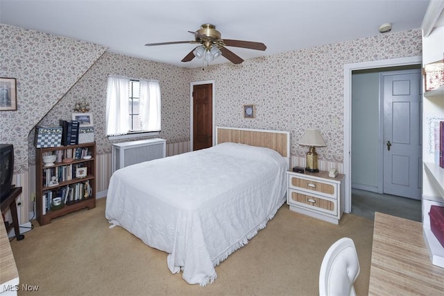 carpeted bedroom featuring radiator, wallpapered walls, and ceiling fan