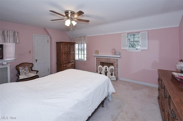 bedroom featuring light carpet, ceiling fan, vaulted ceiling, and baseboards