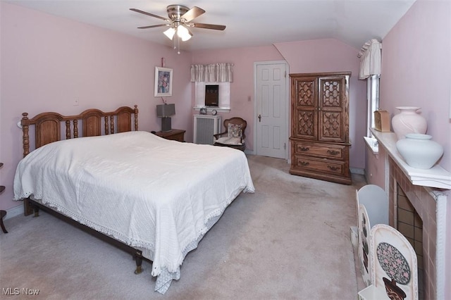 carpeted bedroom featuring vaulted ceiling and a ceiling fan