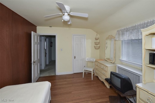 bedroom featuring wood finished floors, a ceiling fan, and baseboards