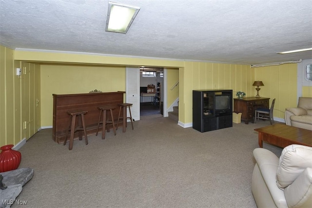 living area with stairs, carpet floors, a dry bar, and a textured ceiling