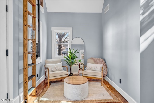 sitting room featuring wood finished floors, visible vents, and baseboards