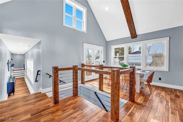 staircase with high vaulted ceiling, baseboards, french doors, beamed ceiling, and wood-type flooring