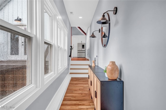 corridor with visible vents, light wood-style flooring, and recessed lighting