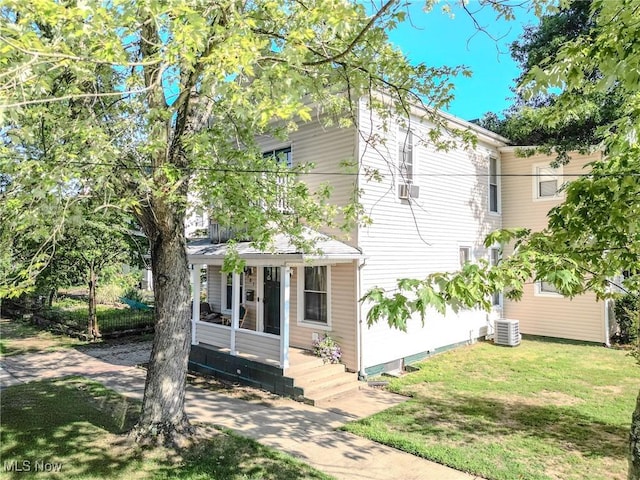 view of front of home with a front lawn and central air condition unit