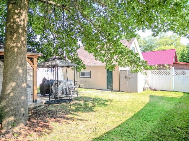 view of yard featuring fence and a gazebo