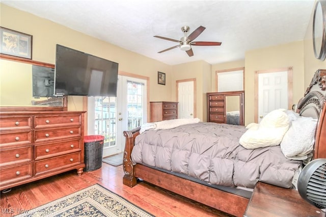 bedroom with access to exterior, ceiling fan, and wood finished floors