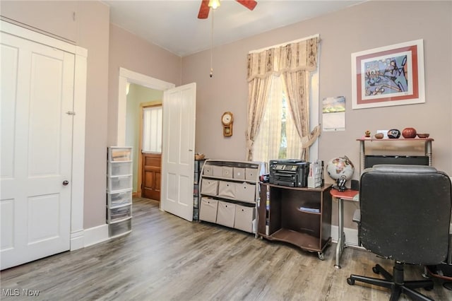 office area with ceiling fan, wood finished floors, and baseboards