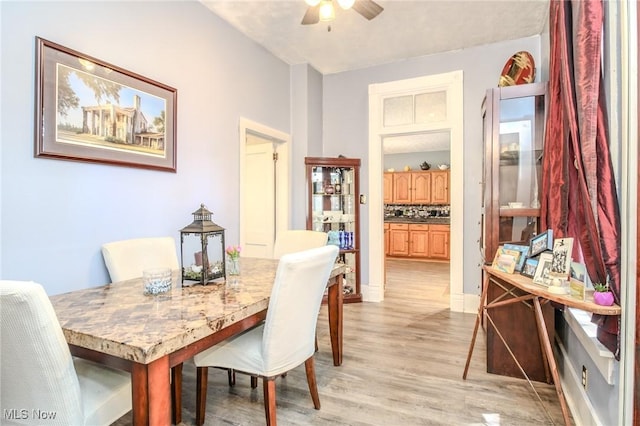 dining room featuring light wood-type flooring and ceiling fan