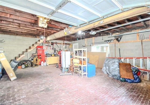 basement with a garage and brick floor