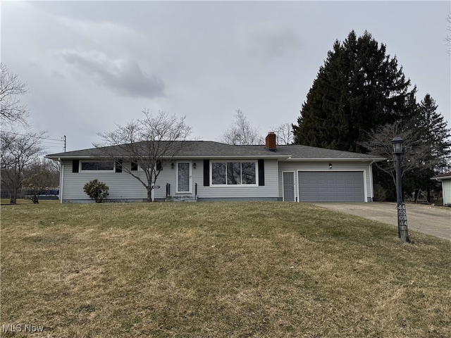 ranch-style house with a garage, concrete driveway, and a front yard