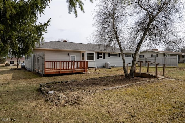 rear view of house featuring a yard, cooling unit, fence, and a wooden deck