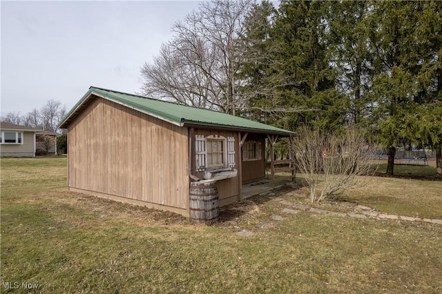 view of outbuilding featuring a trampoline and an outdoor structure