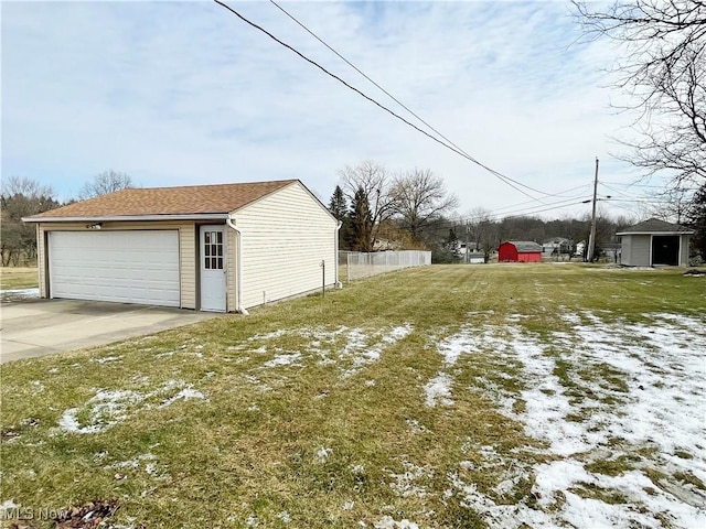 view of yard featuring a garage, an outdoor structure, and fence