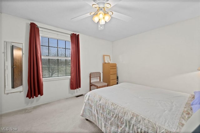 bedroom with a ceiling fan, carpet, and visible vents