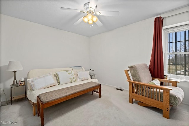 carpeted bedroom featuring visible vents, baseboards, and a ceiling fan