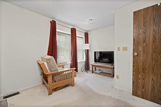 living area with carpet floors, baseboards, and visible vents