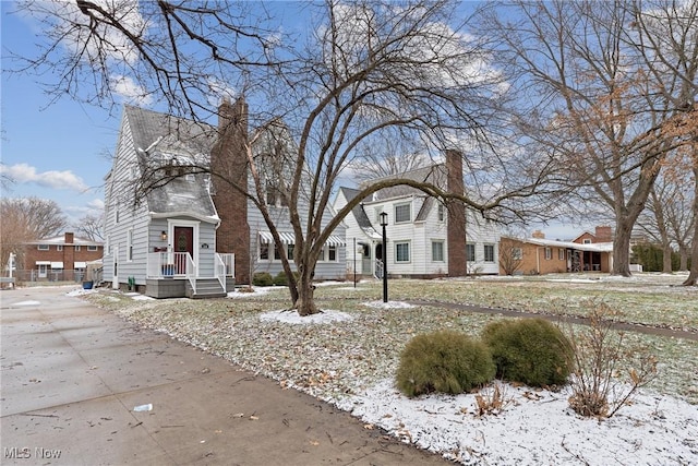 view of front facade with a chimney and a residential view