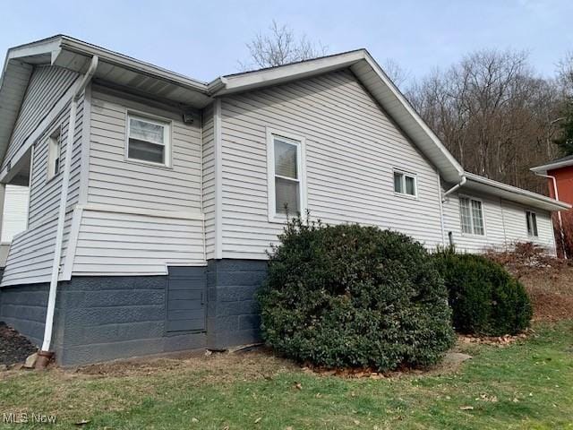 view of home's exterior with a yard