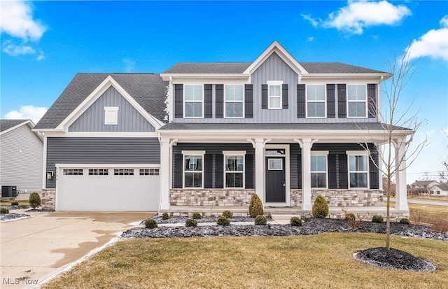 view of front of house with stone siding, a porch, board and batten siding, and concrete driveway