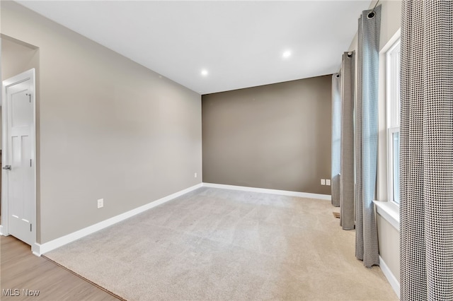 carpeted spare room featuring baseboards and recessed lighting