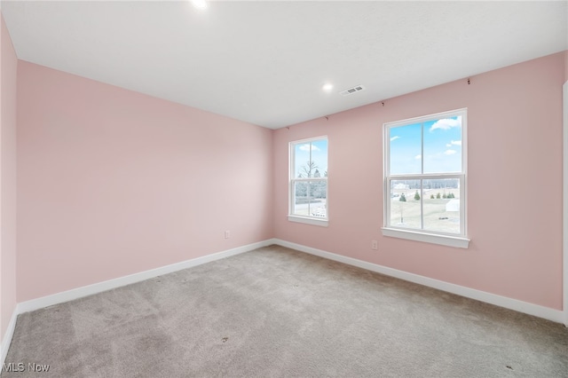 carpeted empty room with recessed lighting, visible vents, and baseboards