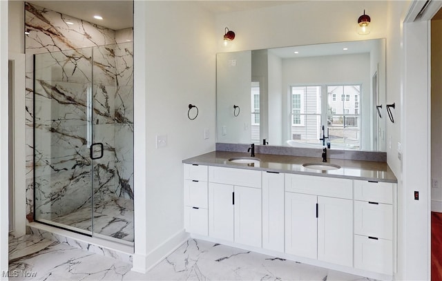 bathroom with marble finish floor, double vanity, a sink, and a marble finish shower